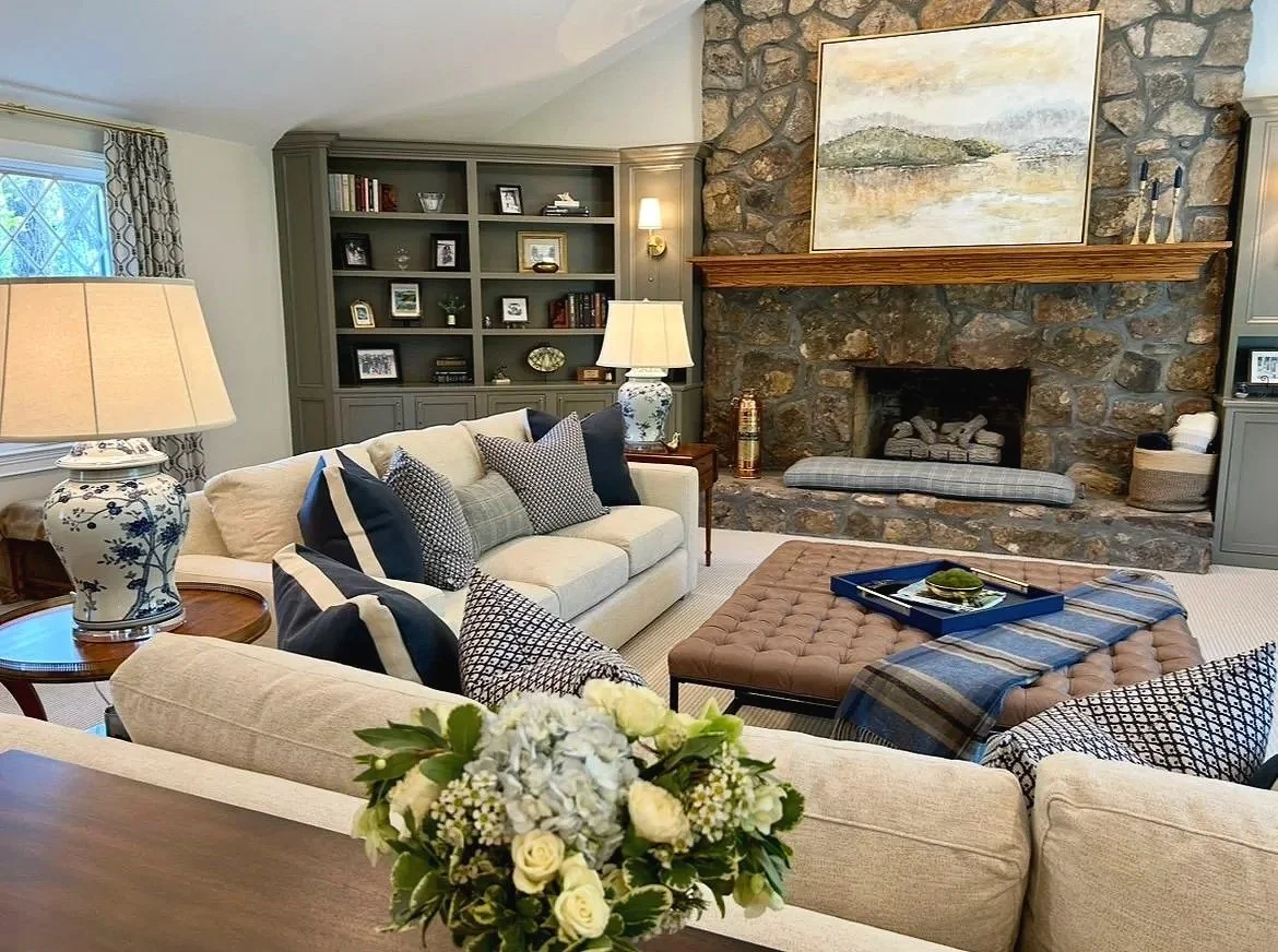 Blue and cream living room with stone fireplace and custom built-in bookcases designed by Chattanooga interior designer McLain Collins Interiors.