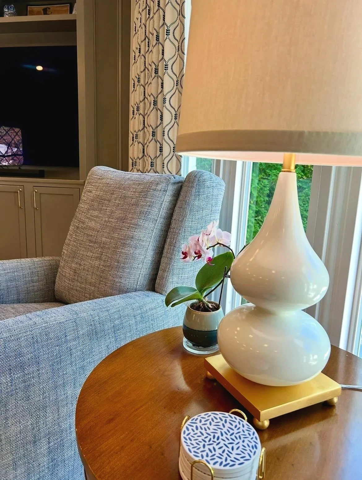 Blue and cream living room with stone fireplace and custom built-in bookcases designed by Chattanooga interior designer McLain Collins Interiors.