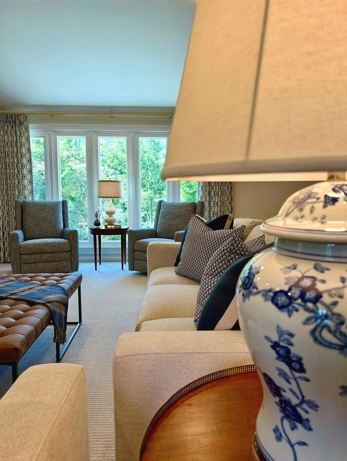 Blue and cream living room with stone fireplace and custom built-in bookcases designed by Chattanooga interior designer McLain Collins Interiors.