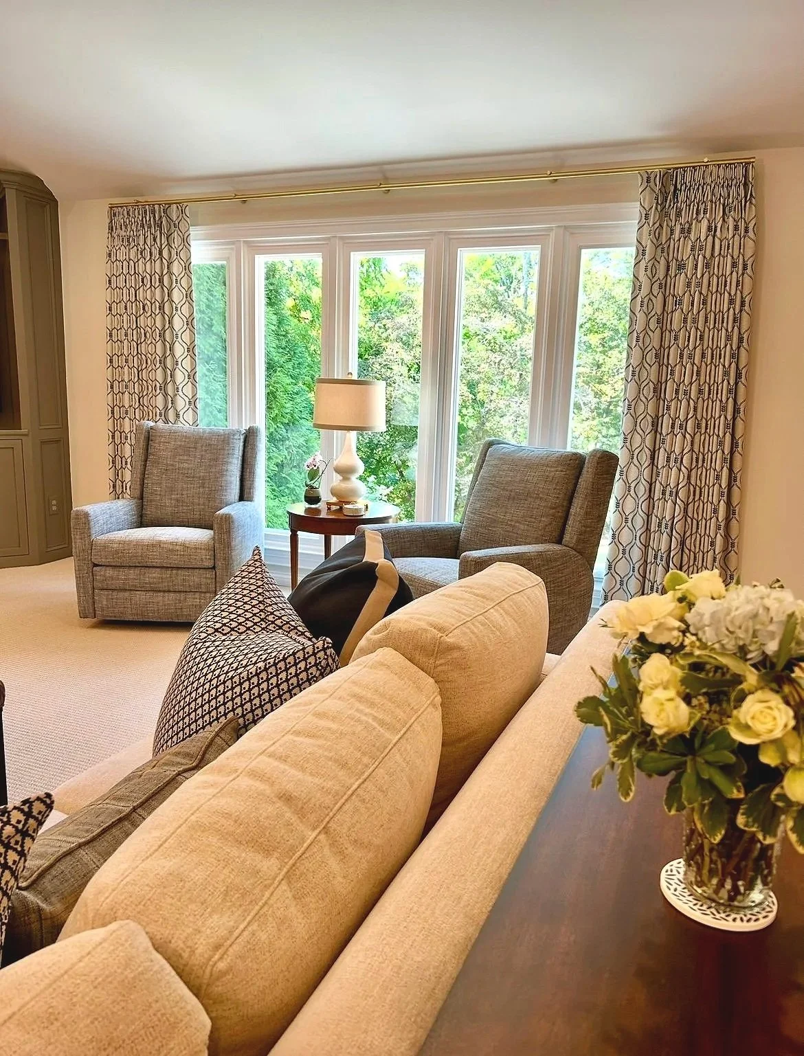 Blue and cream living room with stone fireplace and custom built-in bookcases designed by Chattanooga interior designer McLain Collins Interiors.