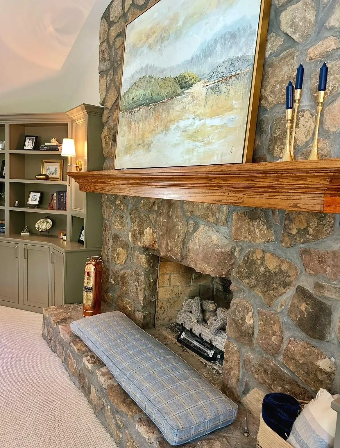 Blue and cream living room with stone fireplace and custom built-in bookcases designed by Chattanooga interior designer McLain Collins Interiors.