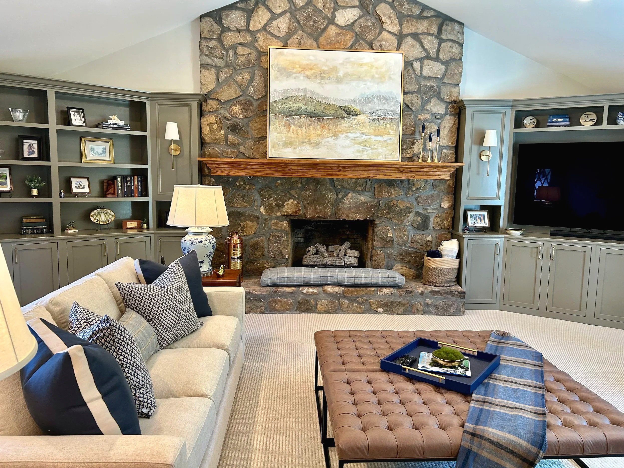 Blue and cream living room with stone fireplace and custom built-in bookcases designed by Chattanooga interior designer McLain Collins Interiors.