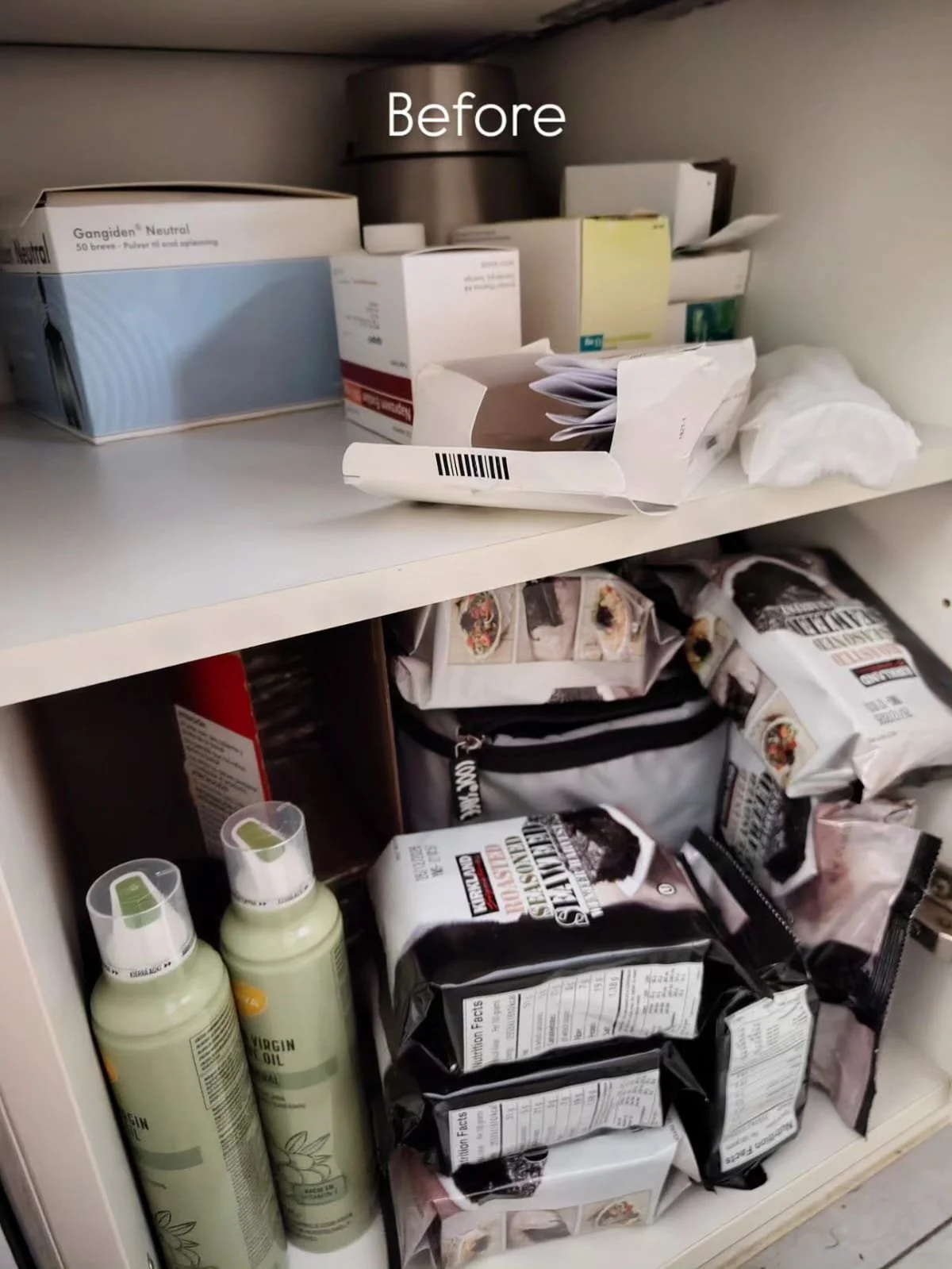 Kitchen cabinet shelf with over-the-counter items including medication or supplement boxes, snack bags, and bottles of oil or lotion.