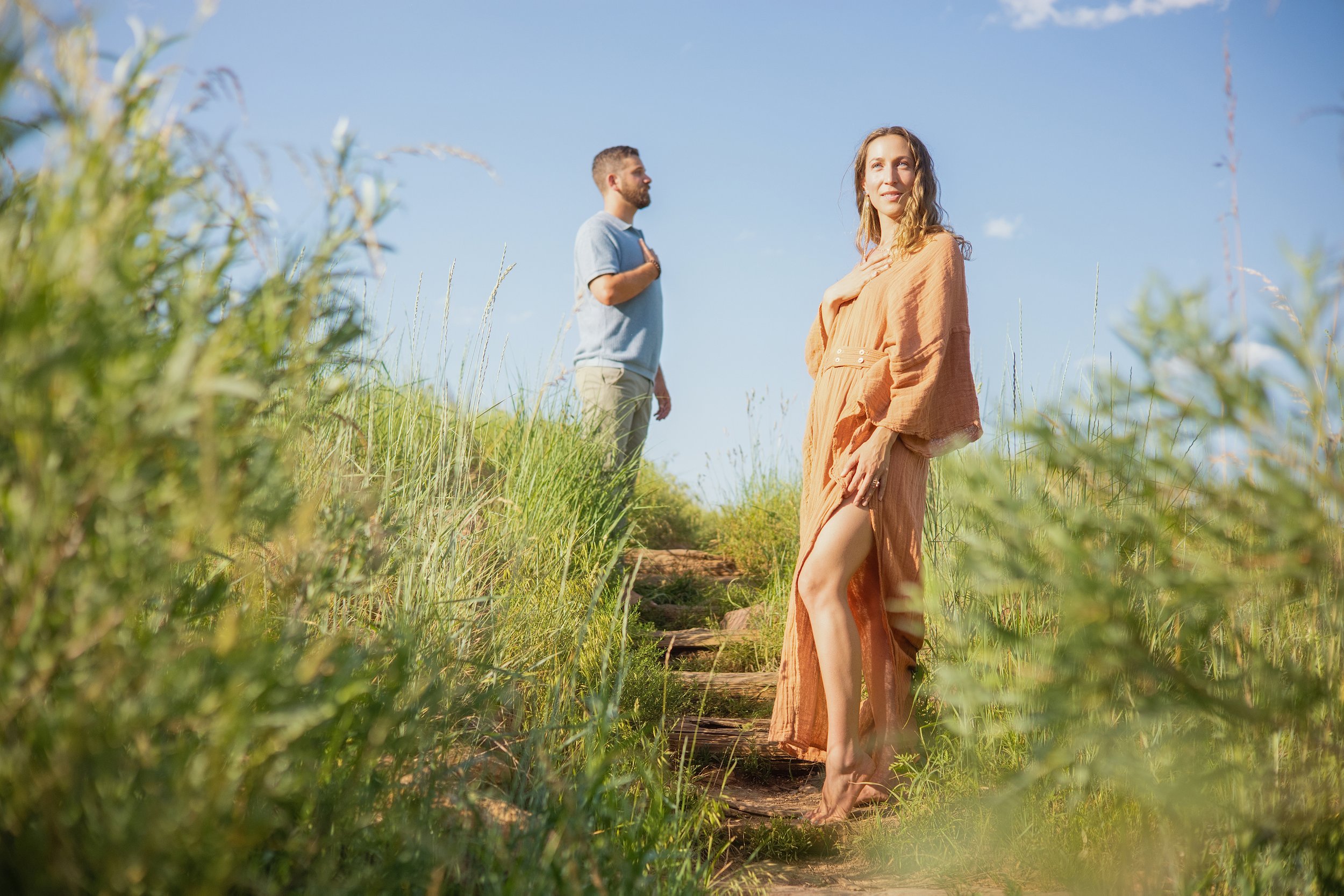 A woman stands barefoot on a grassy path. Embodied presence and heart-centered leadership supporting women entrepreneurs creating businesses aligned with real life
