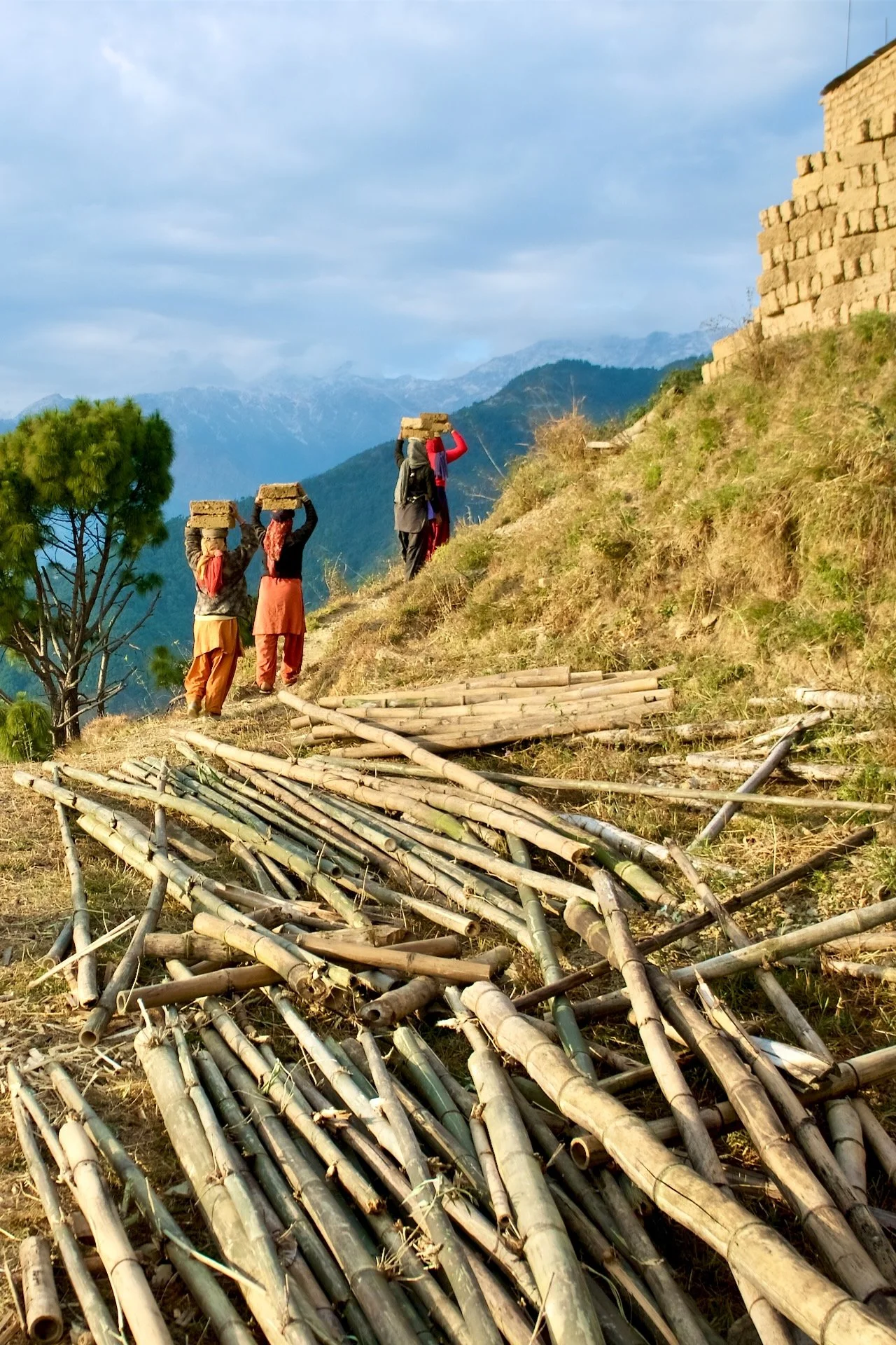Carrying adobe bricks up to the building site
