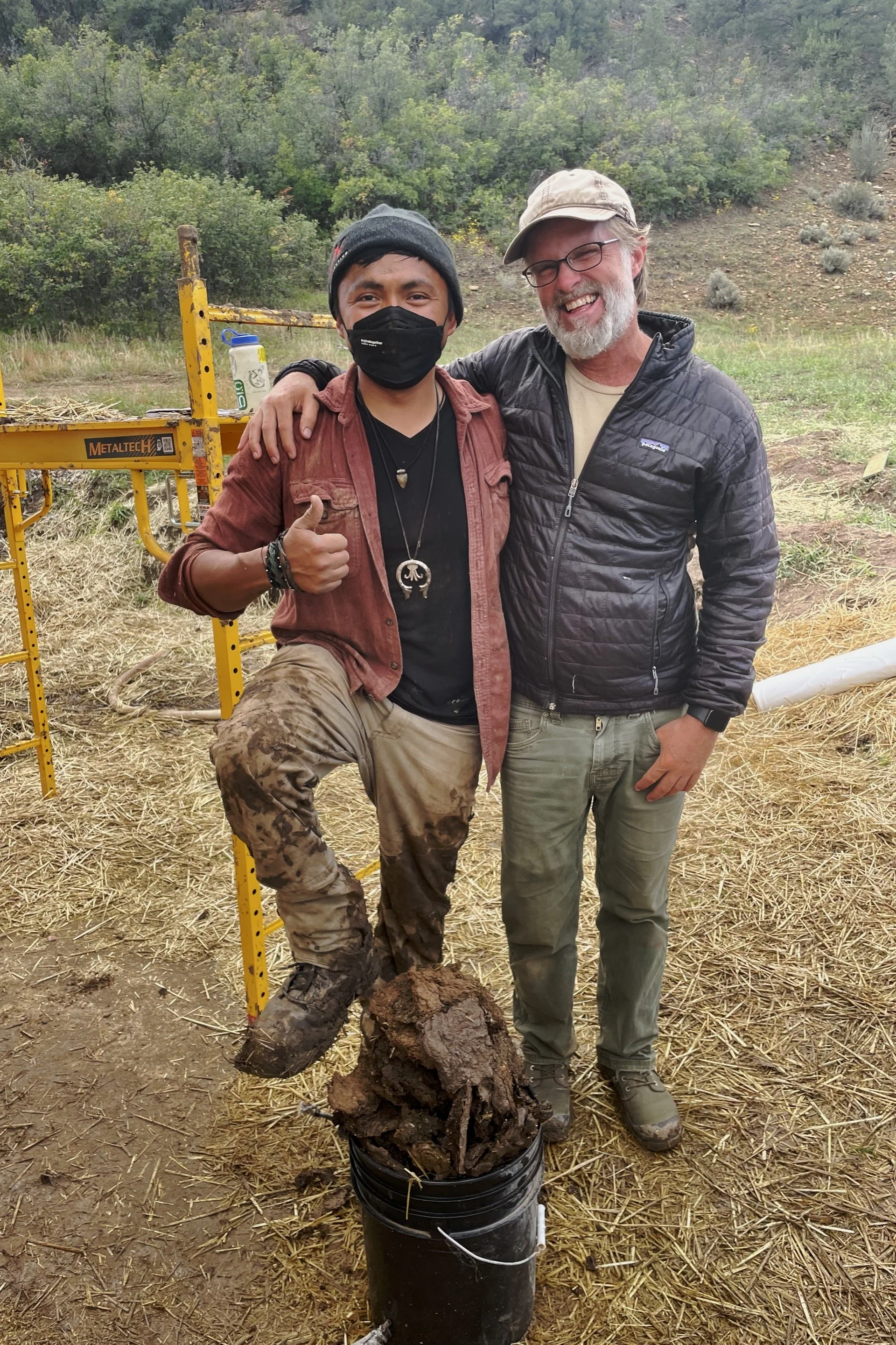 Makai and Mark celebrating the end of a muddy workday