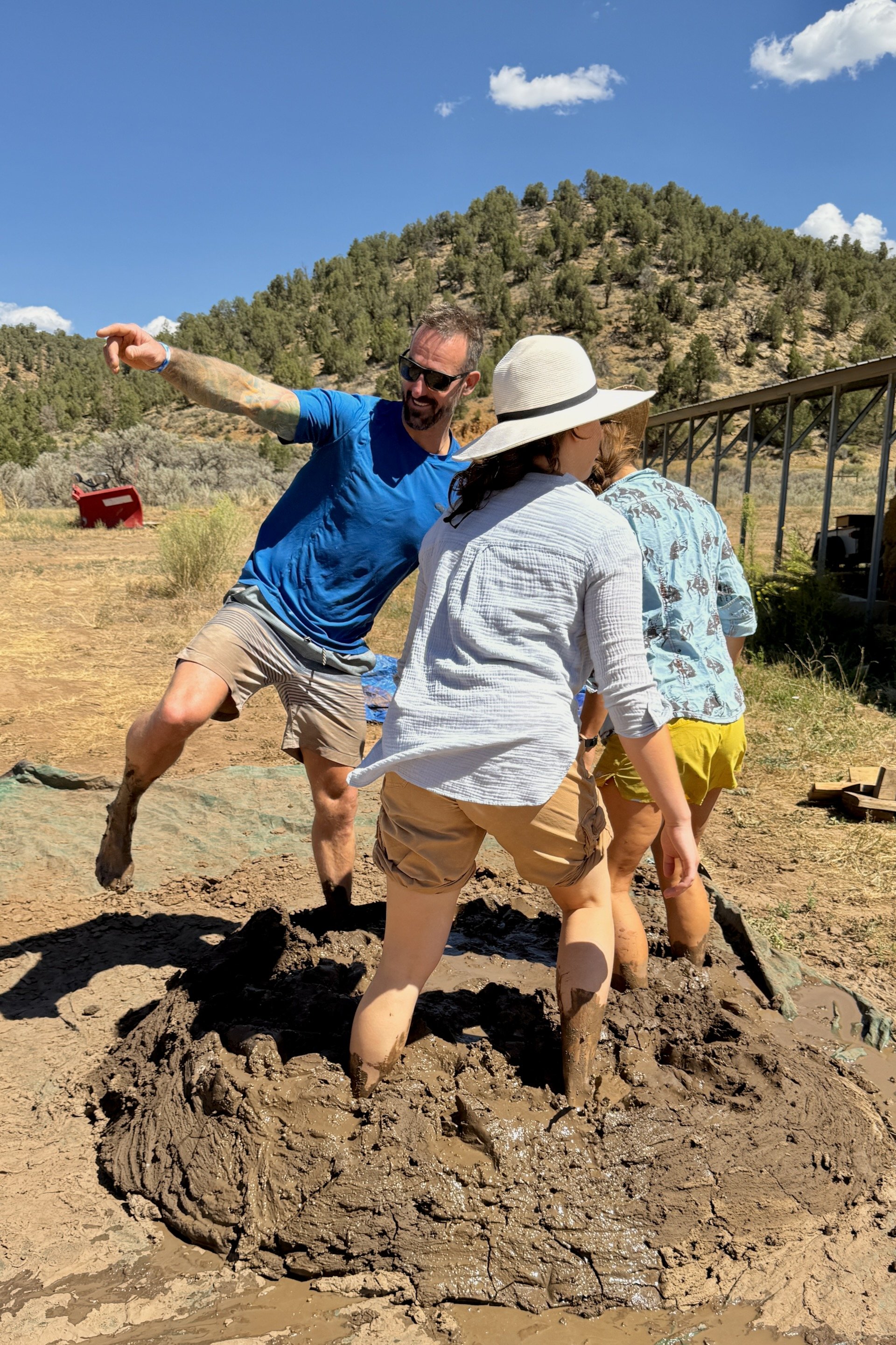 Students pugging a mud mortar mix