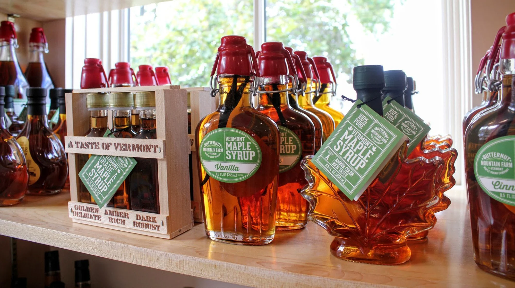 A shelf display in Marvin's Country Store featuring vanilla infused maple syrup and a maple leaf shaped bottle.