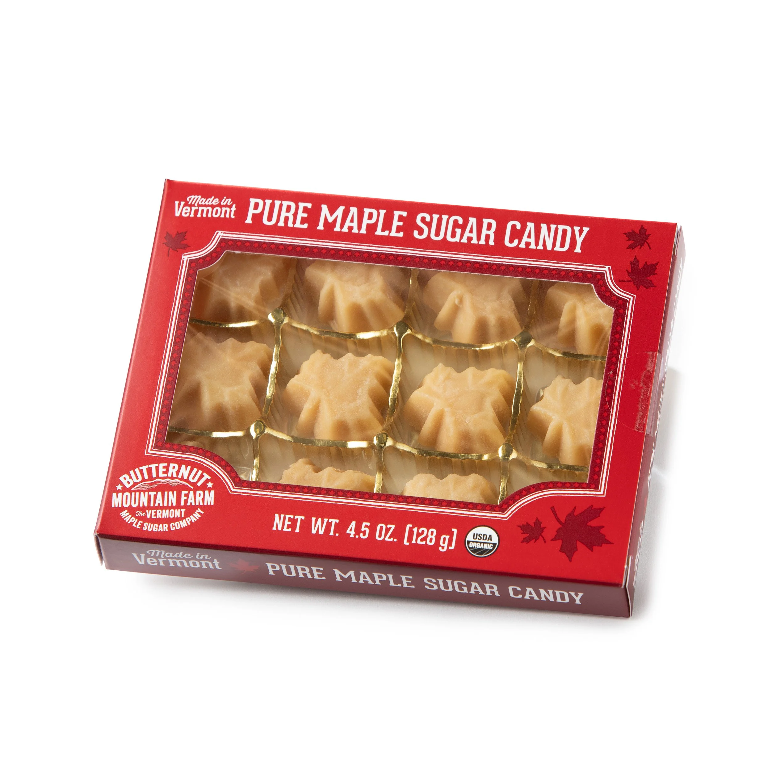 A red cardboard box with a window looking into the maple leaf shaped maple candy.