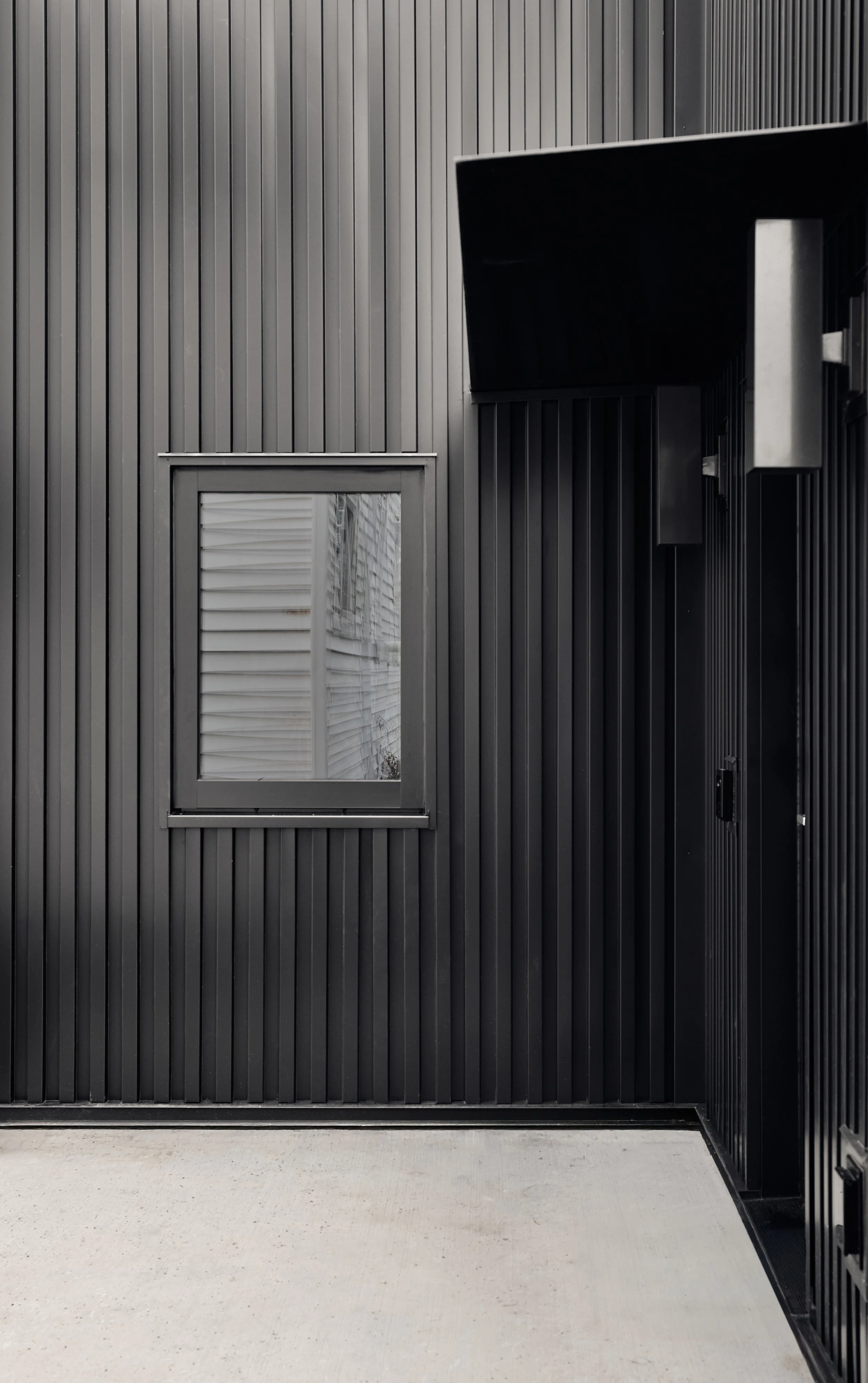 Metal siding, steel awning on ADU.