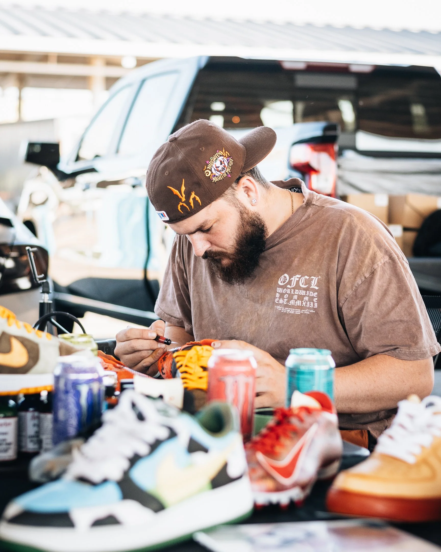 A man customizing sneakers at SNKRville sneaker convention. Photo captured by Treven Warner of Made By Treven.