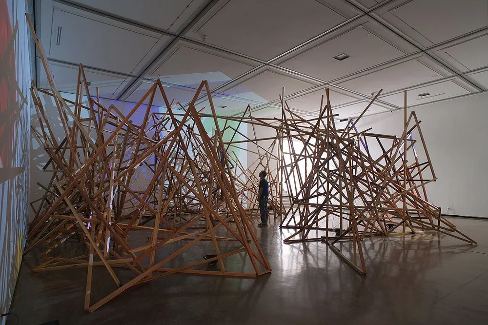  Steve Roden,  bowrain , 2010  Large scale installation, wood, wire, twine, sound composition, 6 audio speakers, 3 cd players, 3 stereo amplifiers, ink on 16mm film stock transferred to video, 3 dvd players, 3 video projectors  Photography by Robert 