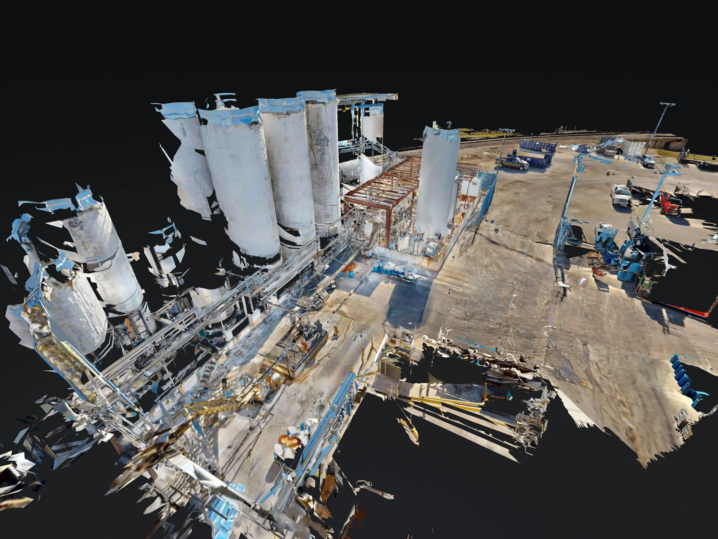 A 3D point cloud rendering of an industrial site with large storage tanks, pipelines, and parked vehicles, set against a black background.