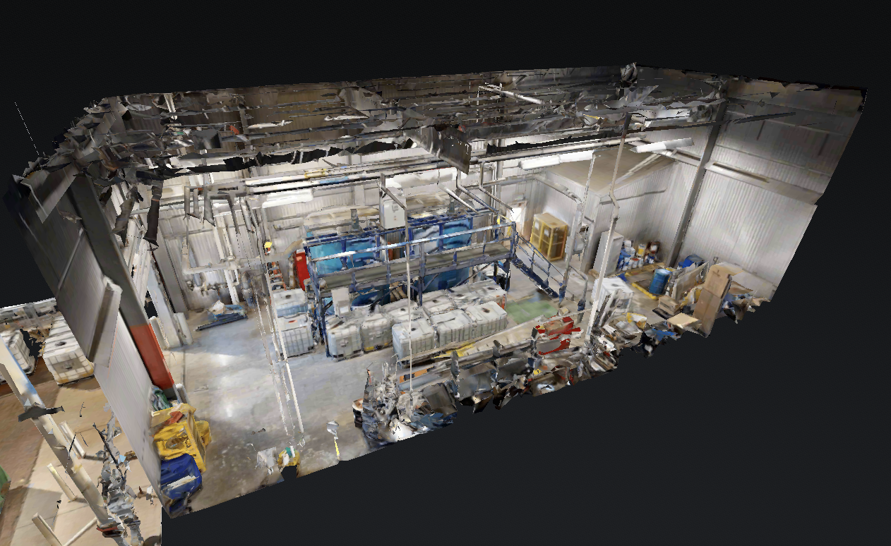 3D scan of an industrial warehouse with equipment, containers, and storage units.