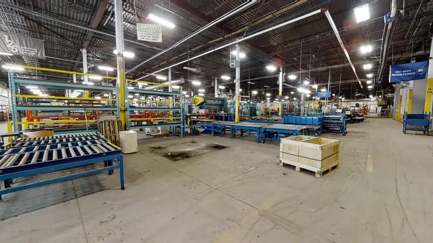 Empty industrial warehouse with racks and conveyor belts for manufacturing or shipping