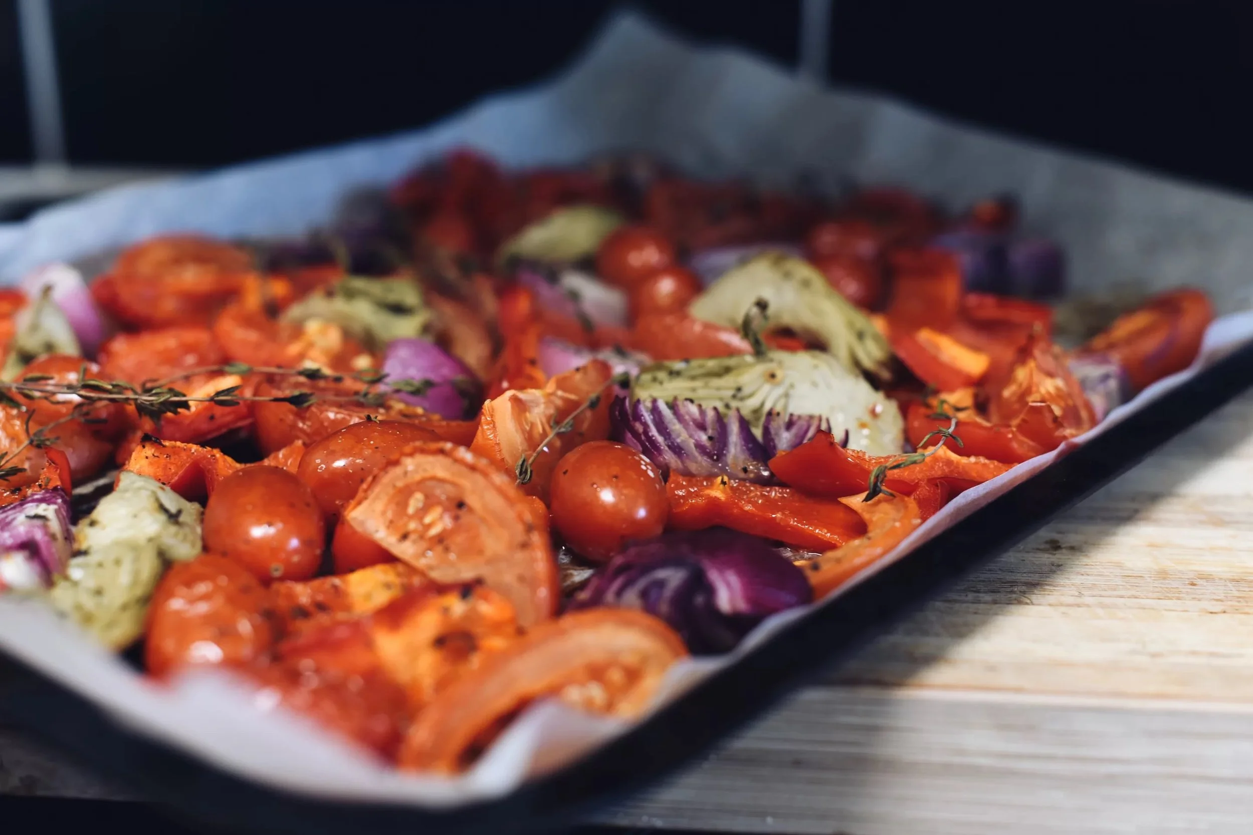 A person holding a brown glass bottle of Untzberg Ginger Ale against a black background.