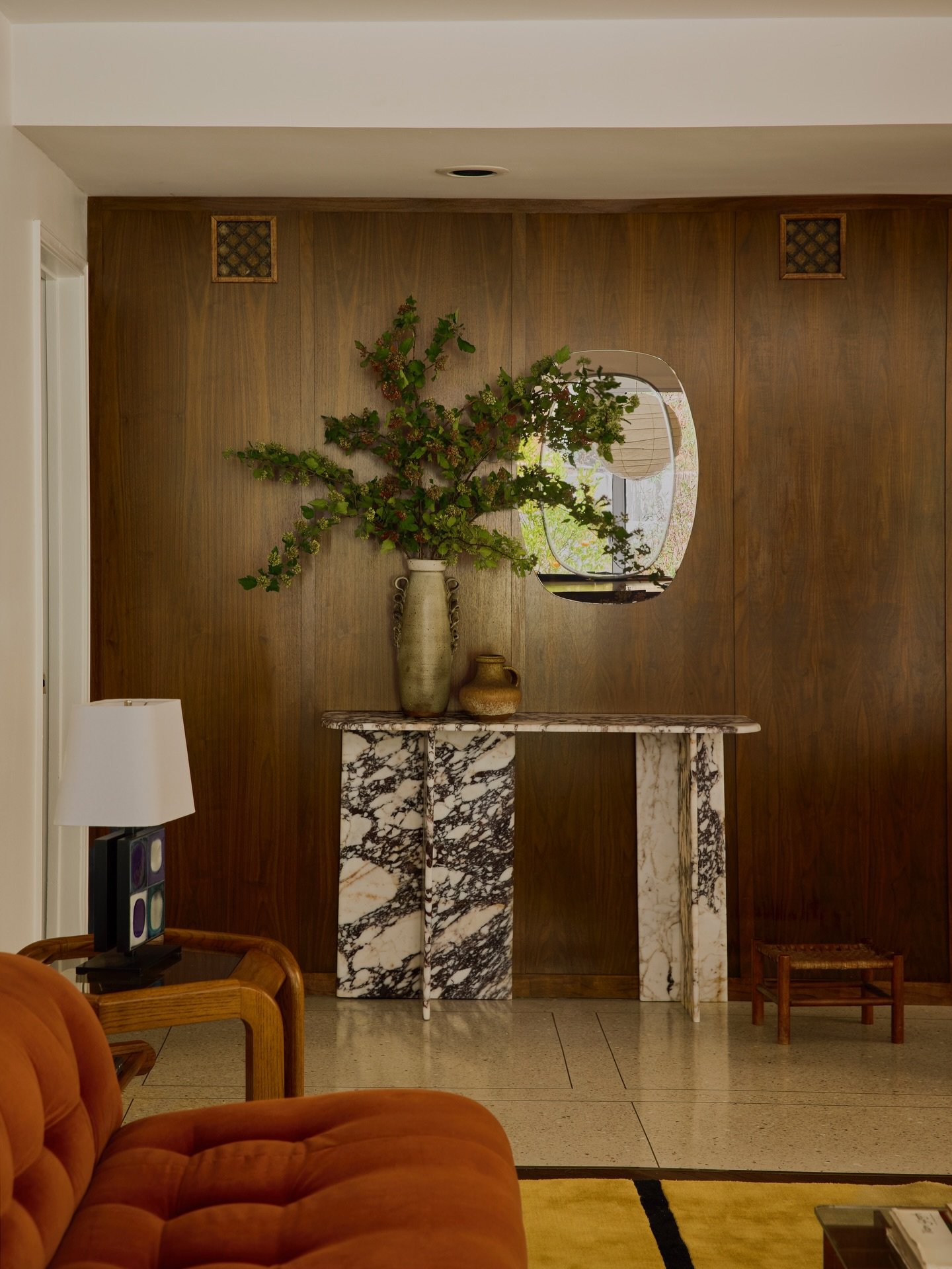 a warm welcome 🗝️

walnut clad entry walls, custom marble console + a 70s Italian two tone mirror