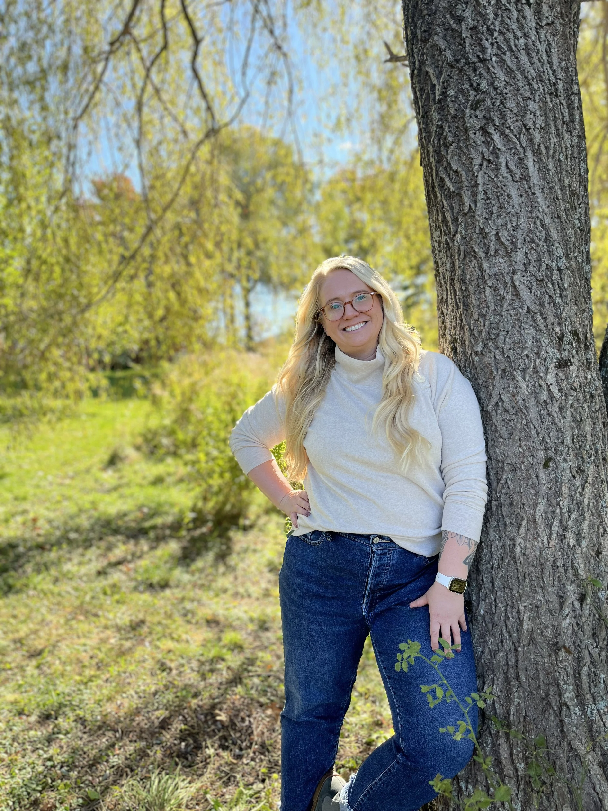 Person standing against a tree
