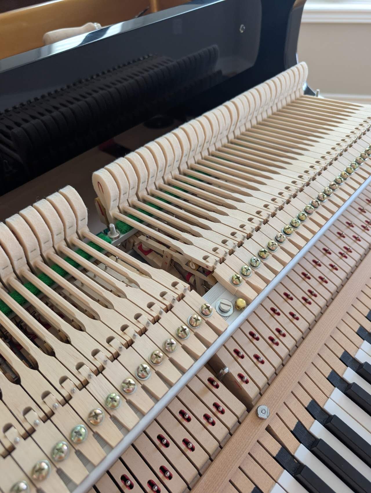 Close-up of a Pearl River grand piano action mechanism - fully inspected by technician