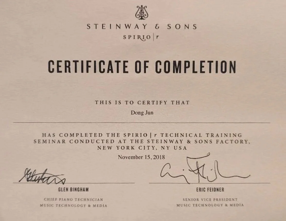 Certificate of completion awarded to Dong Jun for Spirio I/T technical training seminar at Steinway & Sons factory on November 15, 2018, signed by Glen Bingham and Eric Fedner.