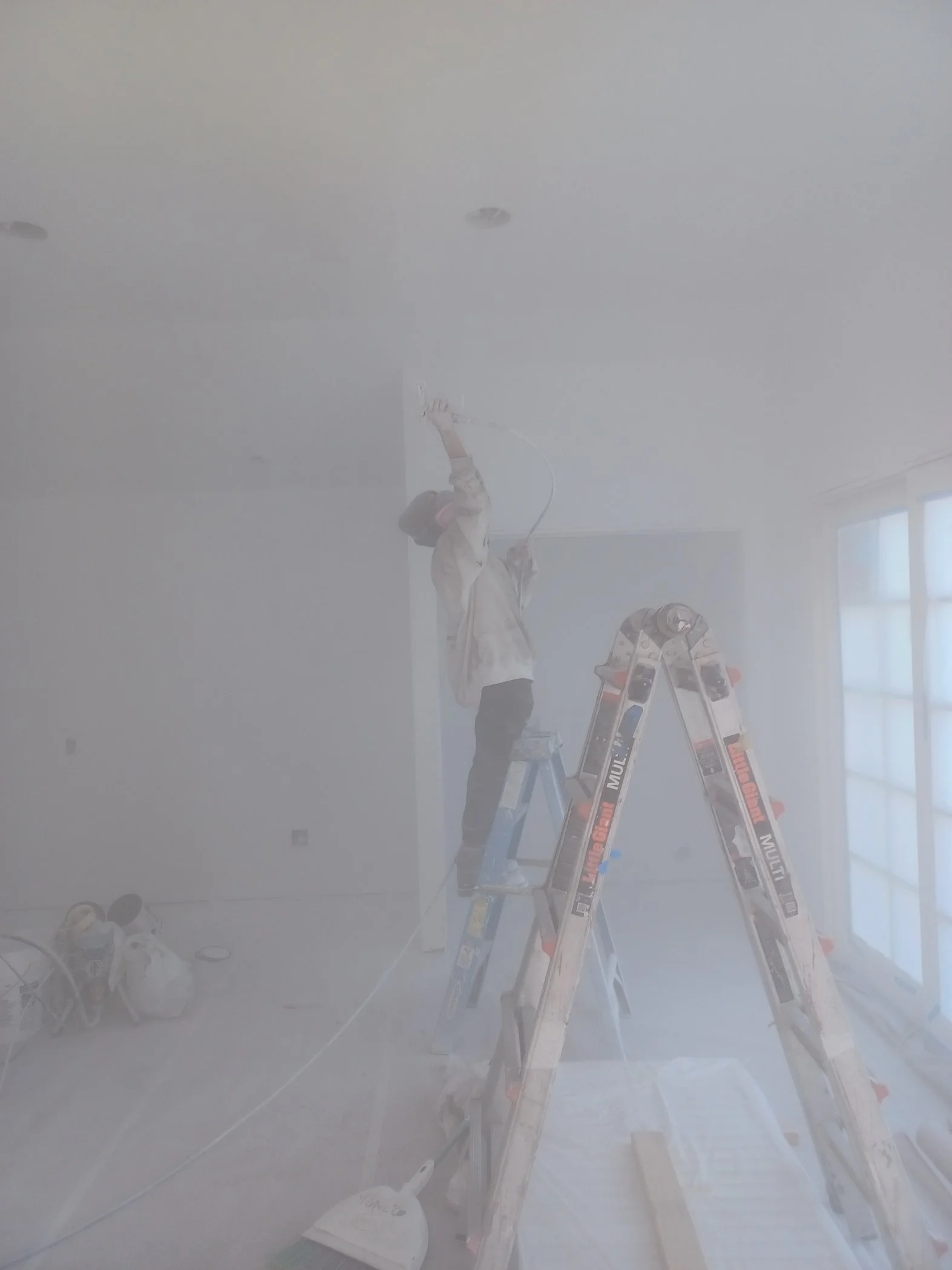 Chelsi Spraying Interior Cieling.jpg