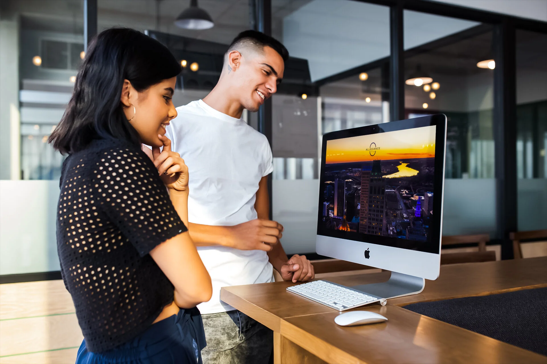 man-and-woman-looking-at-an-imac-mockup-in-a-modern-office-a20764.jpg