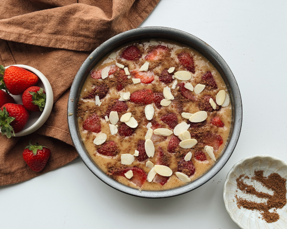 Flatlay of strawberry cake in a cake tin before baking