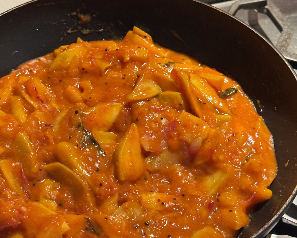 Raw mango curry being cooked.png