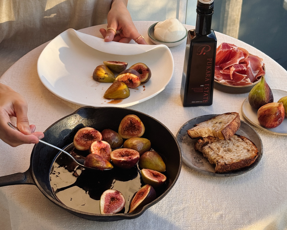  Fresh figs grilling in a cast iron pan with fig balsamic vinegar, served with sourdough, burrata and prosciutto 