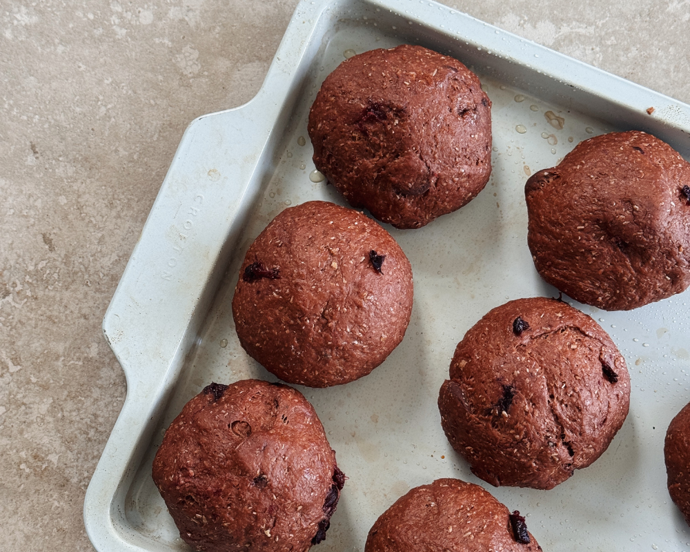  Chocolate cherry hot cross buns on a baking tray, ready for the oven 