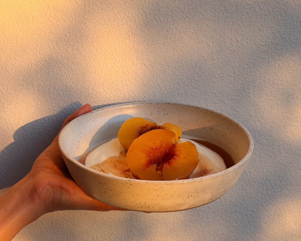  Honey poached peaches in a bowl in dappled sunshine 