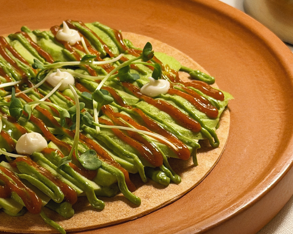  Crispy Avocado Chaat with tamarind chutney and microgreens on a terracotta plate at The Johri Restaurant, Jaipur. 