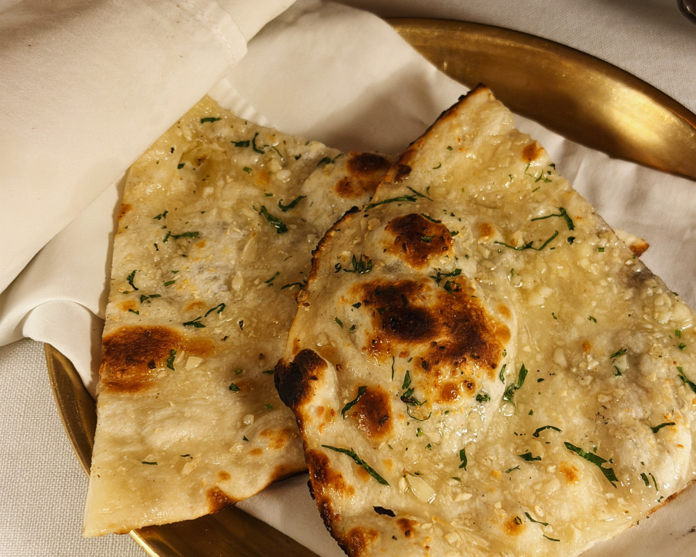  Buttery garlic naan on a brass plate at The Johri Restaurant, Jaipur. 