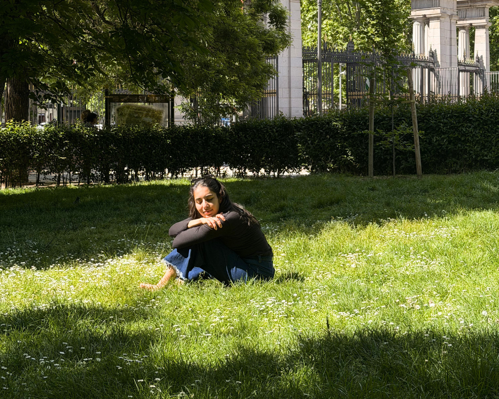  Better With Spice sitting on the grass in El Retiro Park in Madrid. 