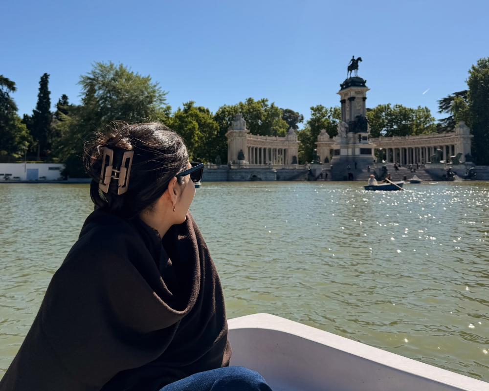  Better With Spice on a rowing boat looking out at the Alfonso XII monument on the lake at Parque del Retiro. 