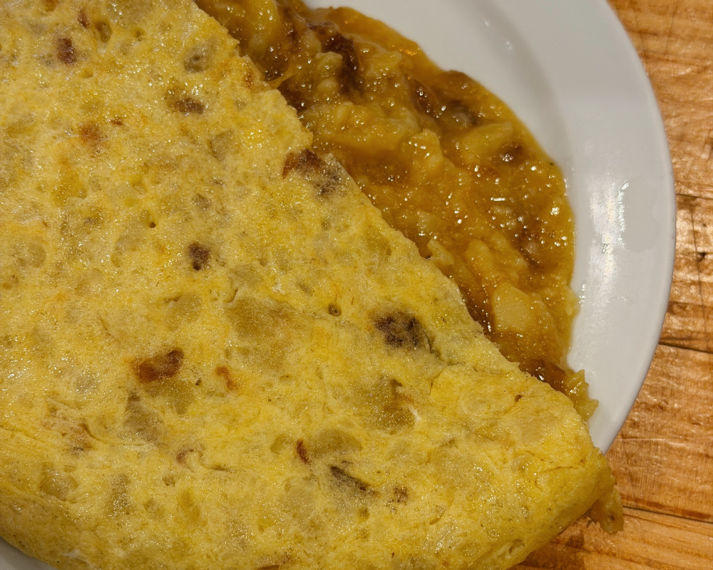  A slice of tortilla española at Casa Dani, with molten potato and egg filling spilling from the centre. 