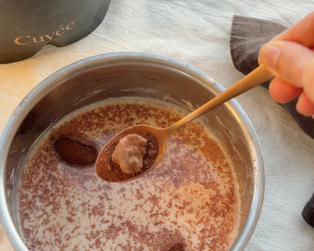  Cuvee’s hot chocolate powder being mixed into warm milk for Chai Hot Chocolate 