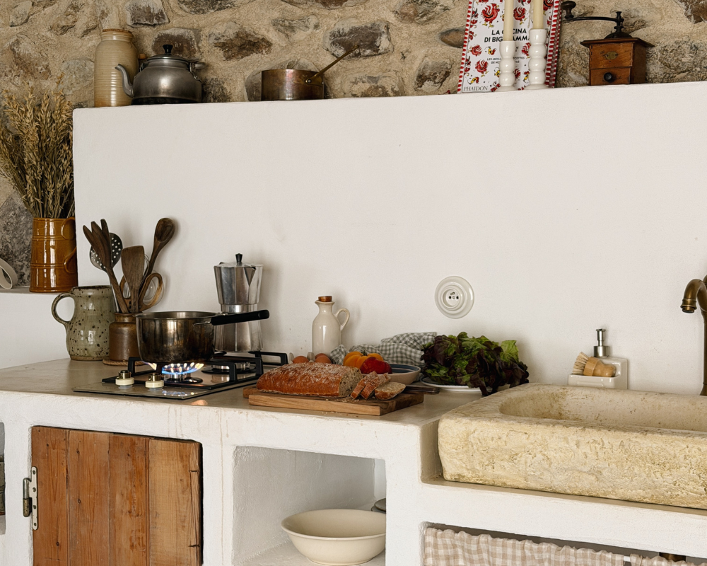  Rustic Mediterranean-style kitchen with fresh bread and produce at Maison Santcha 