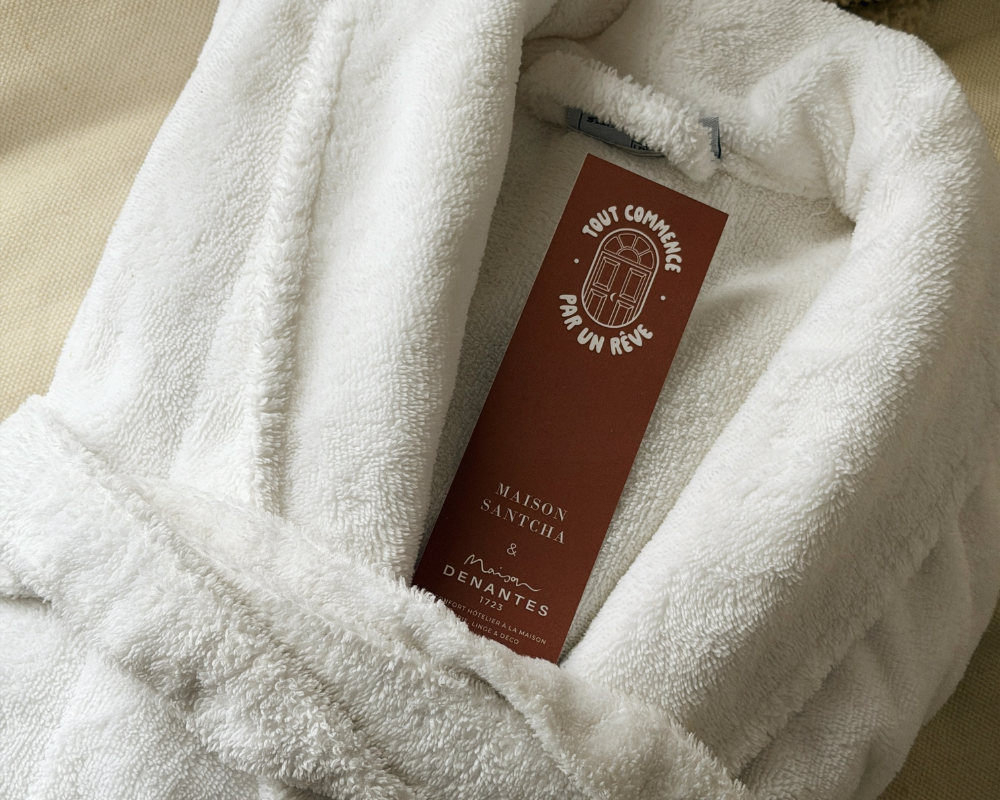  Plush white robe and welcome card at Maison Santcha 