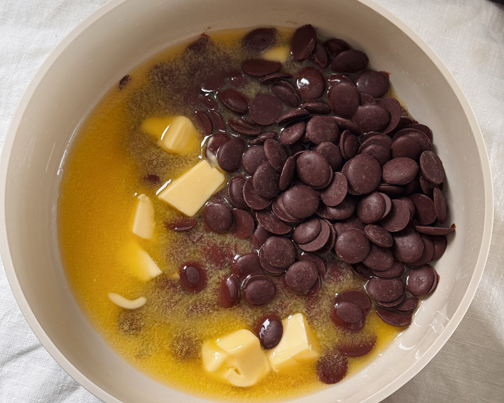  Melted butter and couverture dark chocolate buttons for baked chocolate ganache  