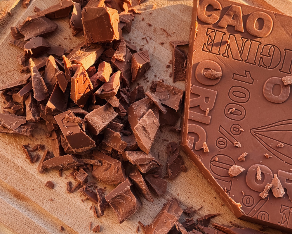  Wooden chopping board with chunks of gianduja chocolate  