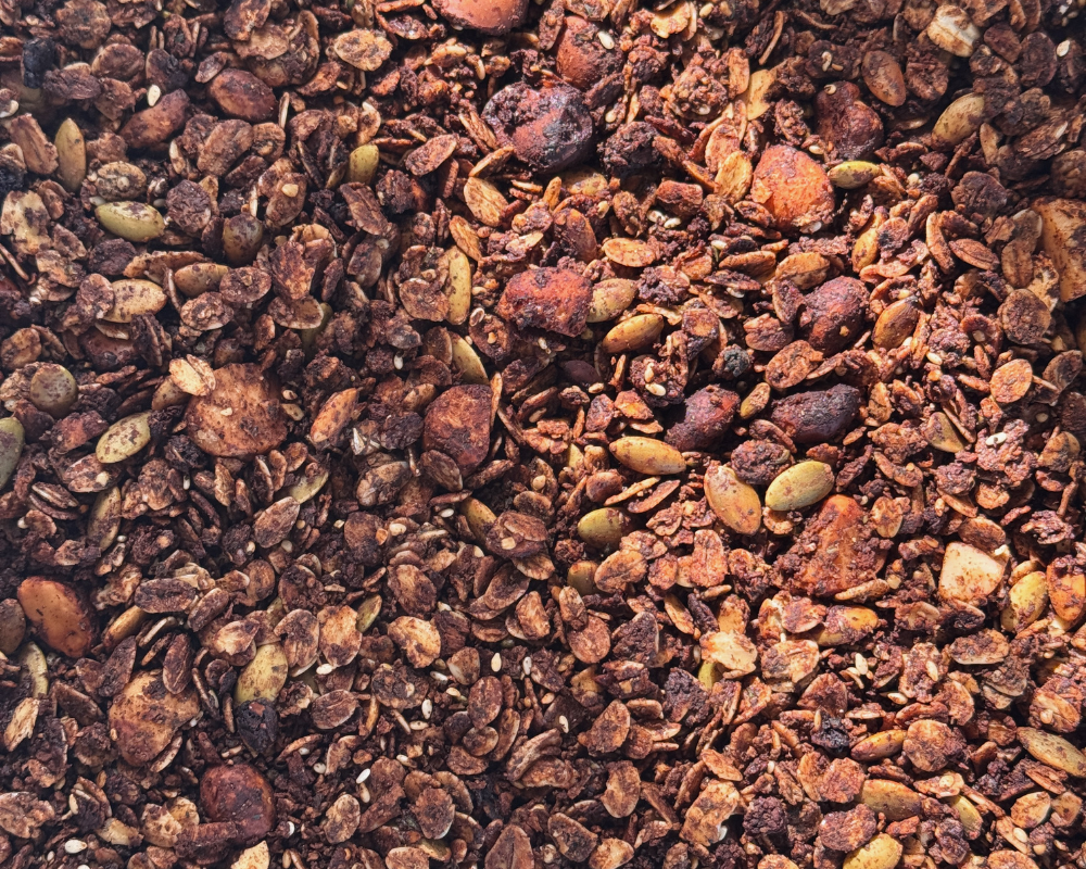  Close-up of homemade chocolate granola clusters with pepitas, oats and sesame seeds. 