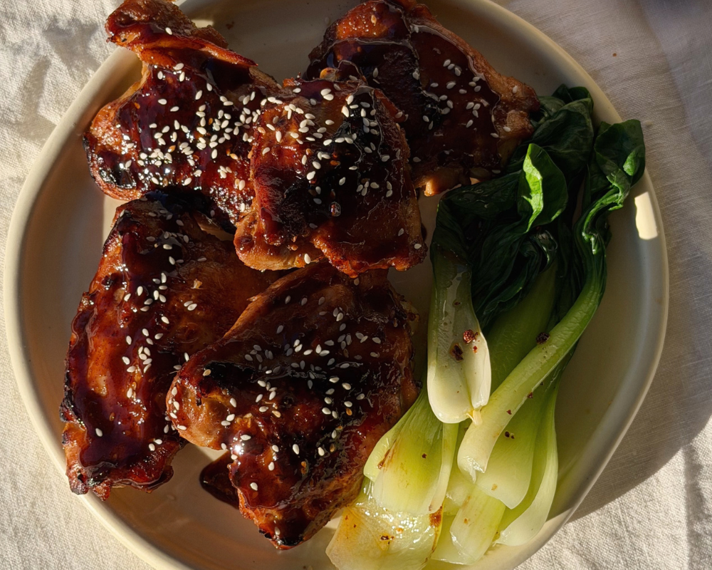  Sticky miso honey chicken on a plate with steamed greens 