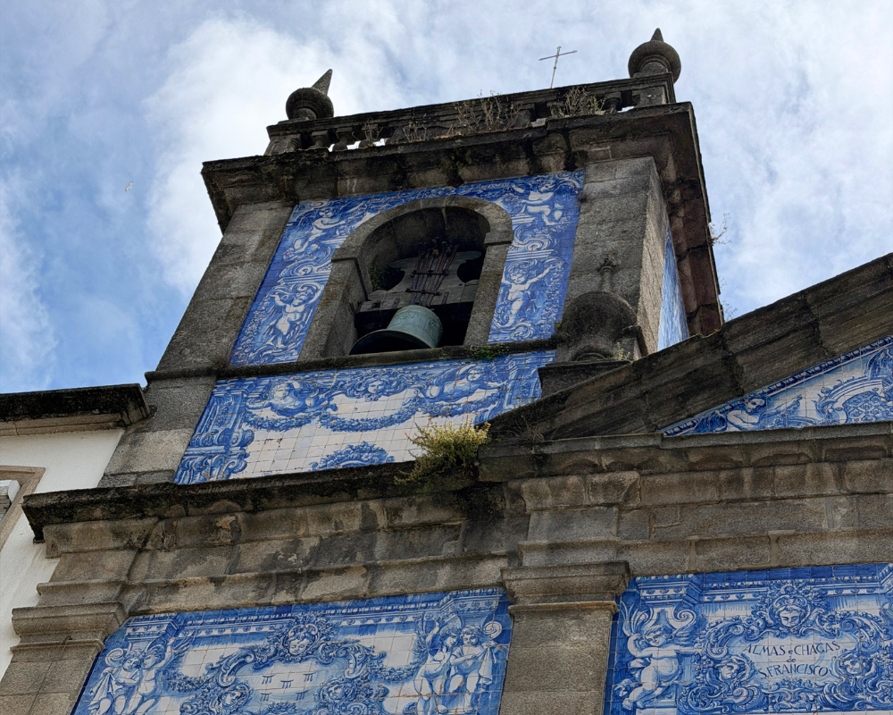  Blue and white azulejo tiles on the bell tower of Capela das Almas in Porto 