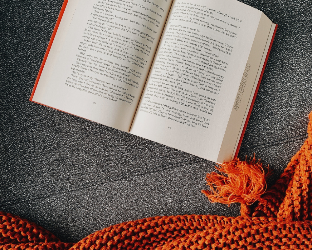 Open book on cosy knit blanket, editorial and print copywriting Sydney