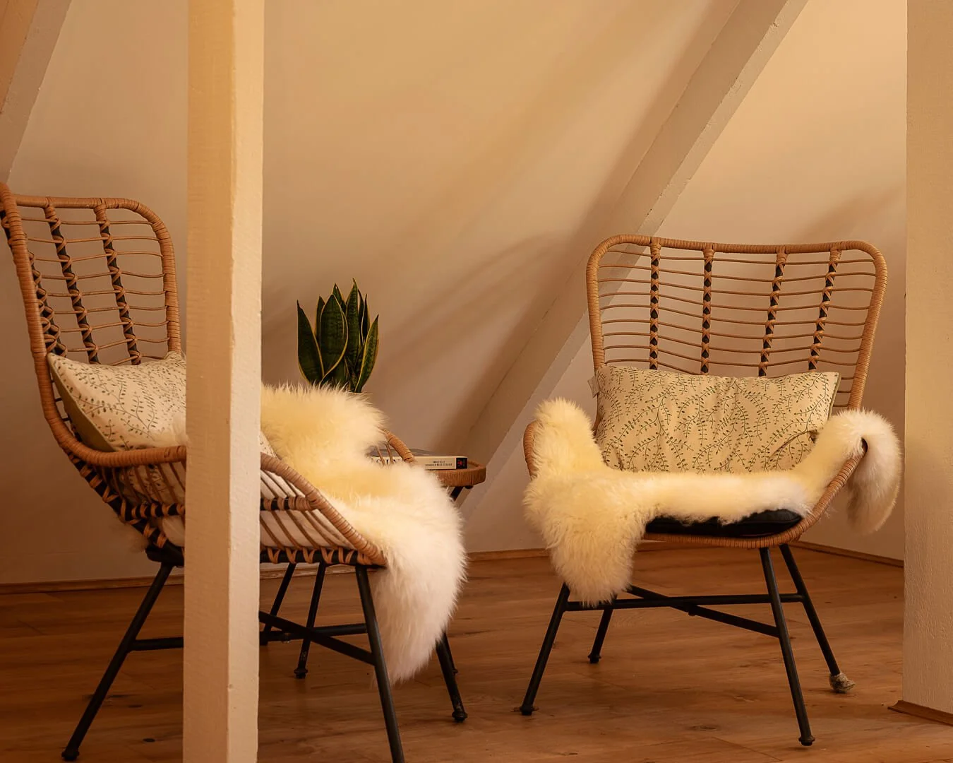 Cosy-rattan-chairs-and-sheepskin-rugs-in-the-snug-room-at-Melancoose-Barn-in-North-Cornwall.jpg