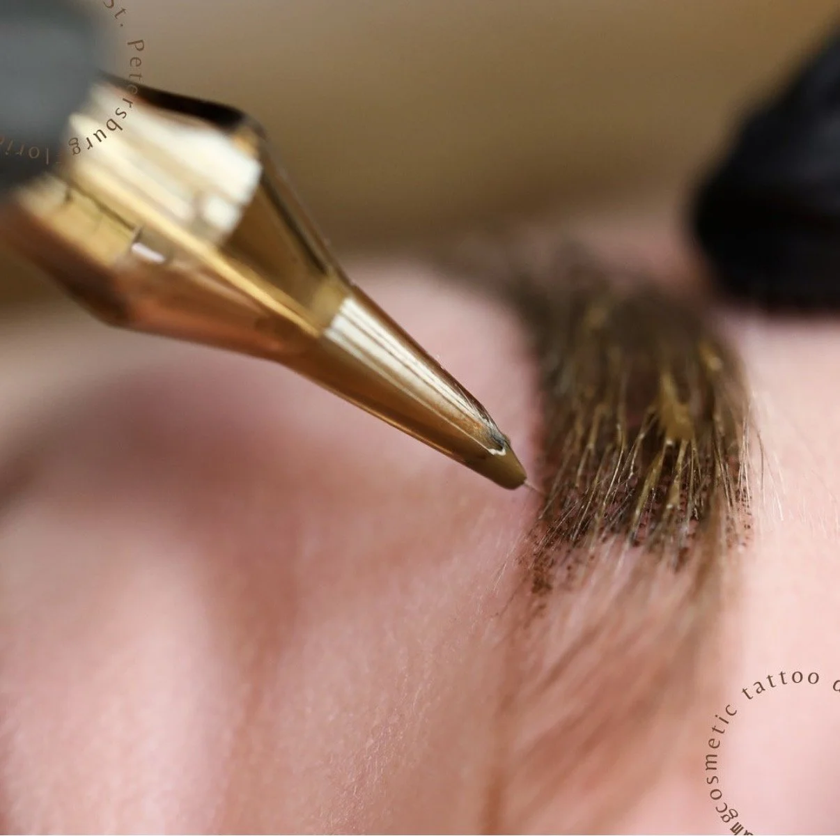 Close-up of a needle applying a cosmetic tattoo or eyebrow tattooing procedure to a person's eyebrow area