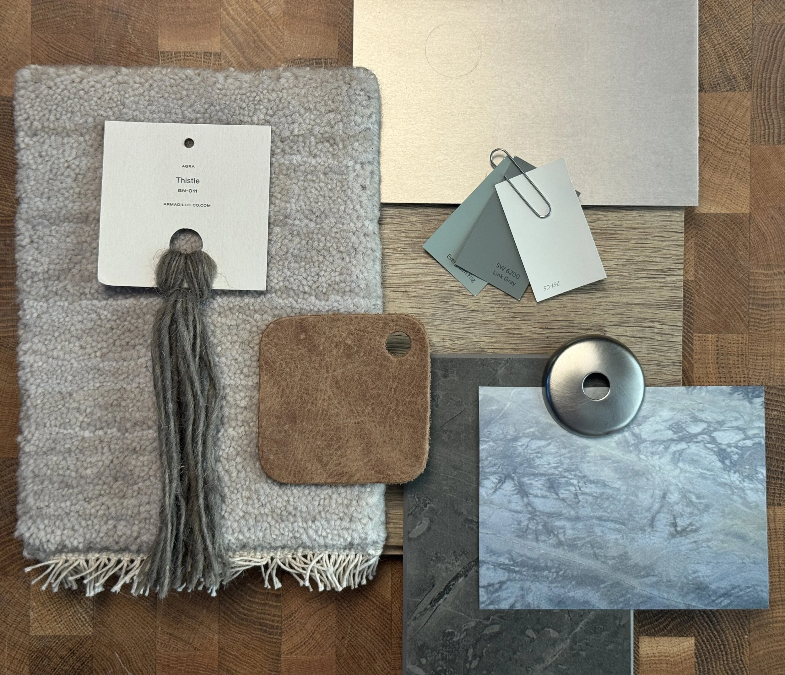 Material samples in desaturated greens, beiges and mossy greys.