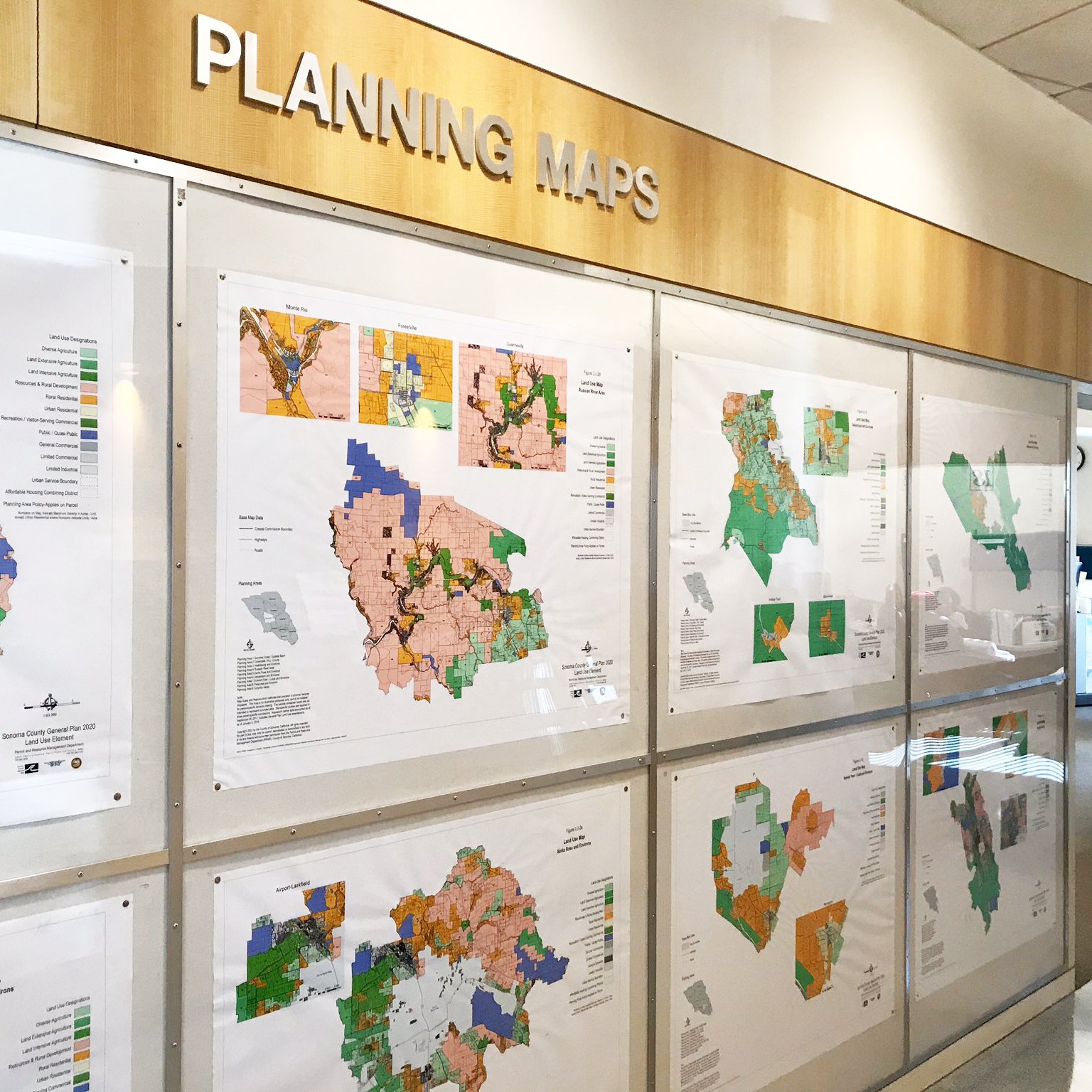 A wall inside a permit office, showing zoning maps
