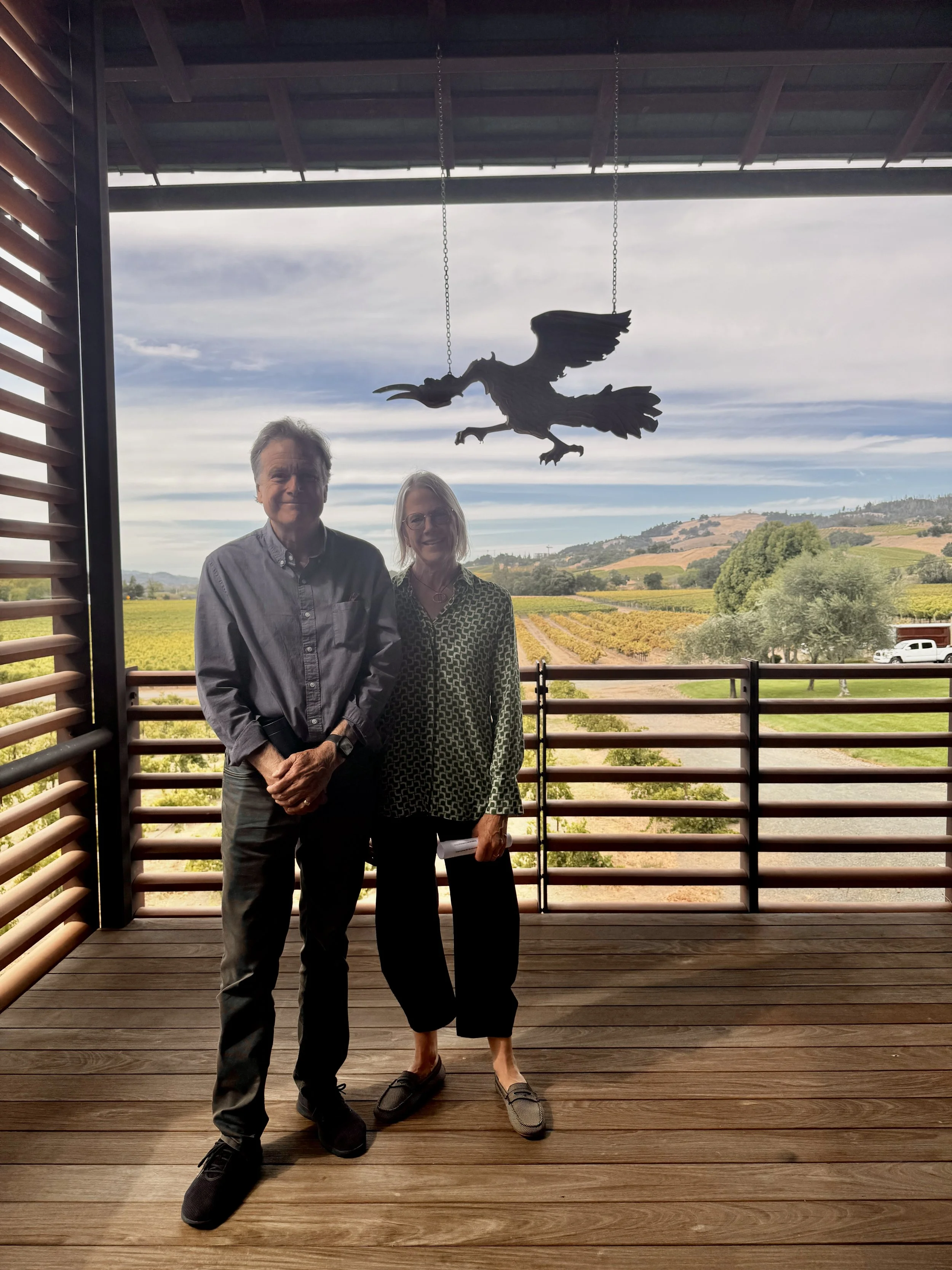 Richard & Amy, the designers of the Banshee Winery standing in front of the vineyard.